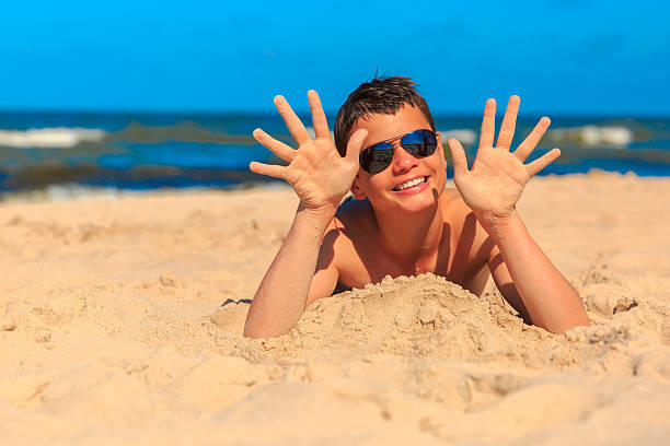 istock Happy young boy on the sea beach 527691099