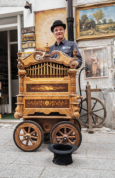 Radovljica, Slovenia, EU - April 16 2016: Street performer is making music with the old music box in the streets of Radovljica, there was a chocolate festival.