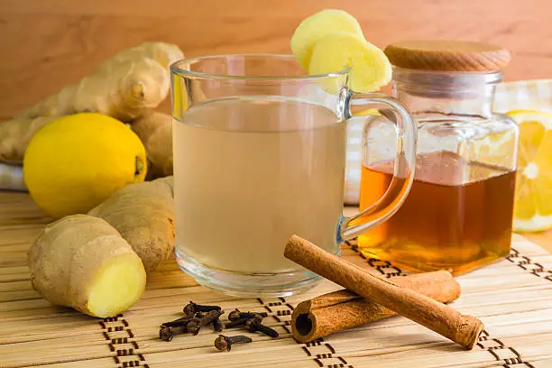 ginger tea with all the ingredients like ginger itself, lemon, honey and cinamon