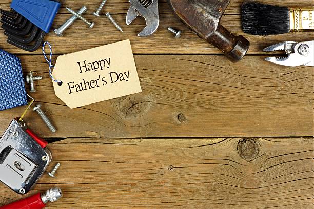 istock Father's Day tag and corner border of tools on wood 527692010