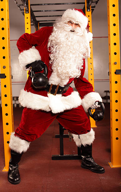 istock Santa Claus training before Christmas in gym - kettlebells 527693615