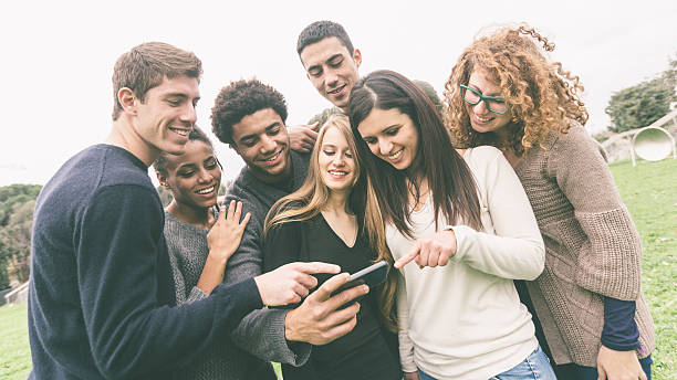 istock Multiethnic Group of Friends Looking at Mobile Phone 527694429