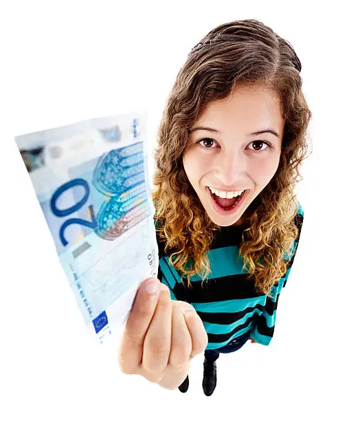 An exaggerated high-angle view of a delighted young woman looking up, holding up a 20 Euro note. Isolated on white. Fish-eye lens exaggerates the perspective.