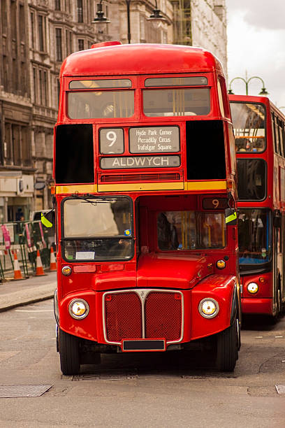 istock Old London bus being followed by a newer model 527694767
