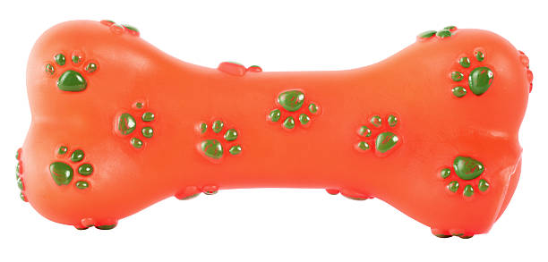 istock Bone rubber toy for dogs orange with green paws 527695237