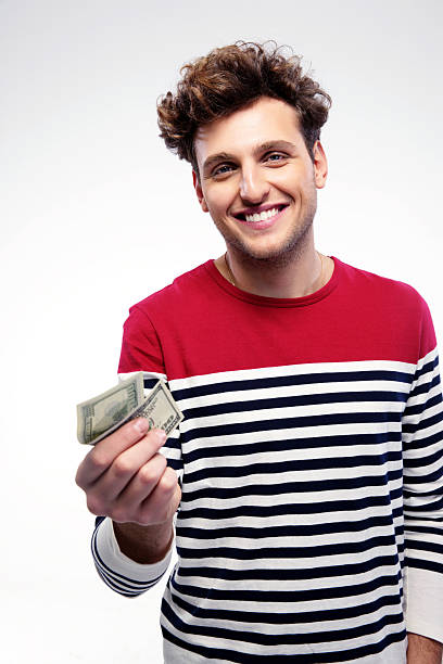 istock Smiling man holding money 527700675