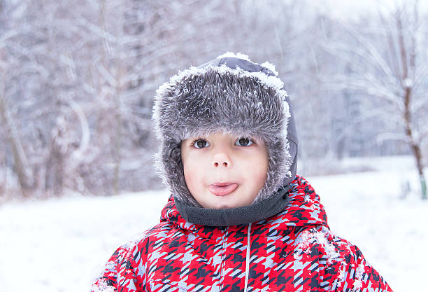 istock Little cute boy showing (poking out, sticking out) his tongue. 527703659
