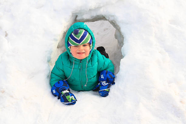 istock Little boy having fun in winter snow 527706095