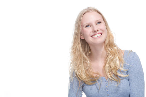 istock Young blonde woman smiling against white background 527707627