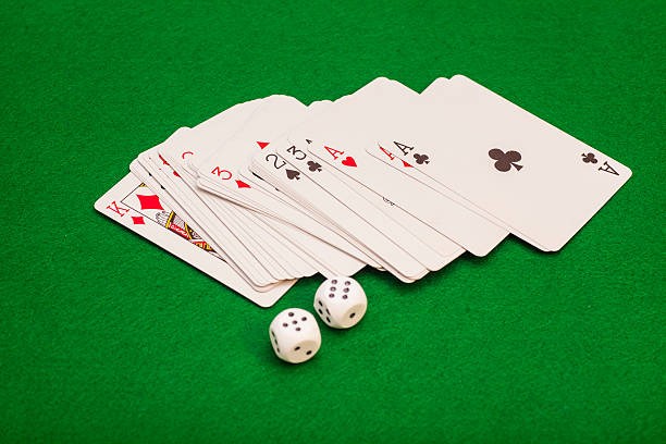 istock Two White Dices And Playing Cards On Green Cloth 527707907