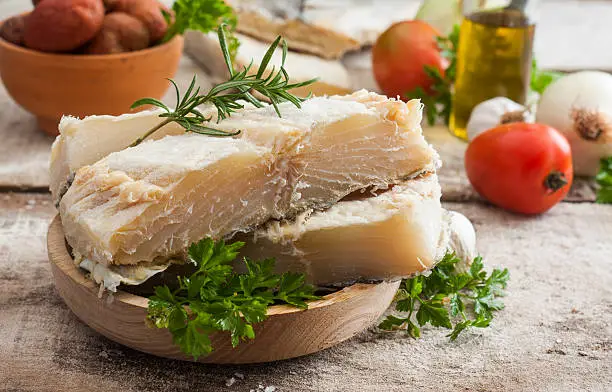 salted codfish on the wooden table with ingredients