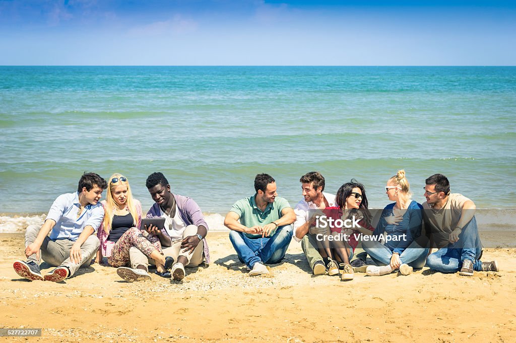 Group Of International Best Friends Sitting And Talking At Beach Stock Photo  - Download Image Now - iStock
