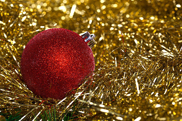 istock Red christmas ball with yellow tinsel 527722909