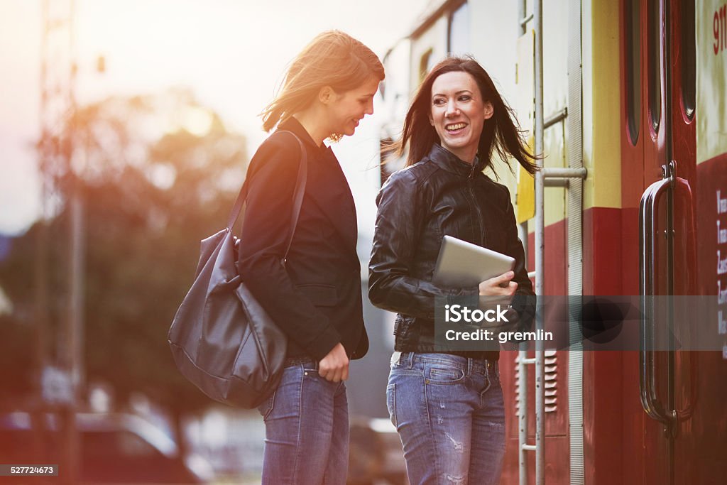 Young women waiting on the train station, leaving, tourist Young women waiting on the train station, digital tablet, leaving, tourist. Adult Stock Photo
