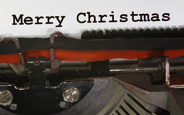 istock old Typewriter Types MERRY CHRISTMAS  Closeup with black ink 527725577