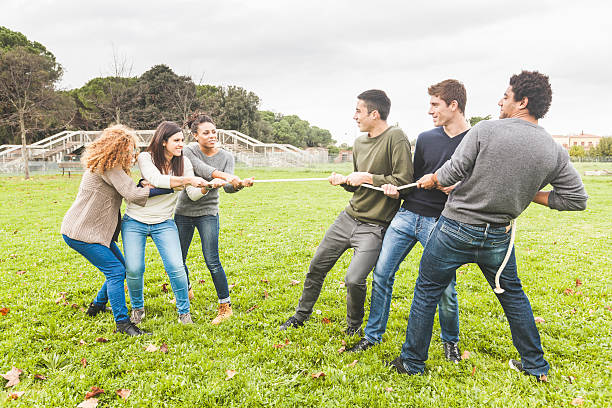 istock Multiracial People Playing Tug of War 527727845