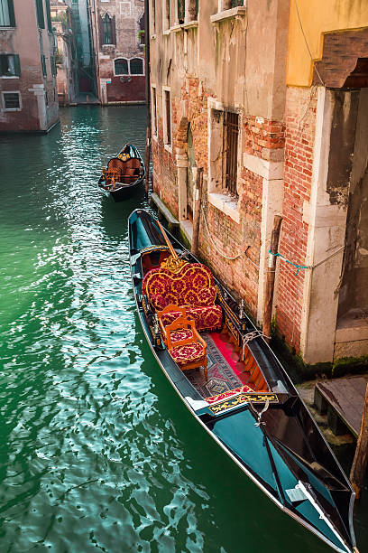istock Beautiful gondolas on a canal in Venice 527743341