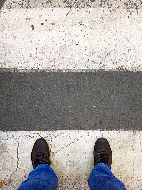 istock Feet on the pedestrian crossing. 527743593