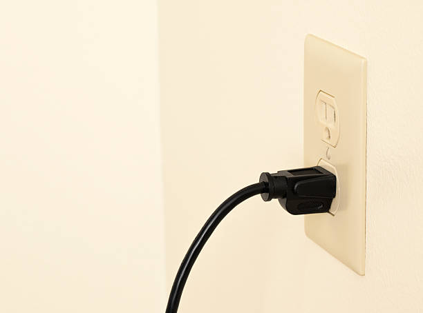 istock Electric cord plugged in to a wall outlet 527744743