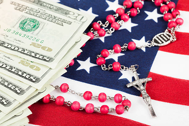 istock Rosary and US currency on US flag 527744745