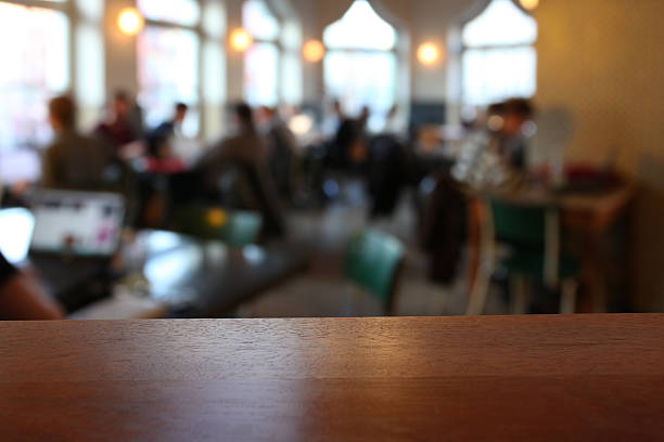 istock Close-up of empty table in a cafeteria, blurred background 527745063