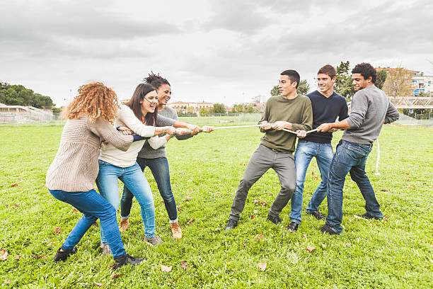 istock Multiracial People Playing Tug of War 527746587