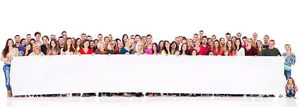istock Large group of smiling people holding banner. 527748871