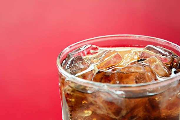 istock Glass of cola soft drink with ice cubes 527758095
