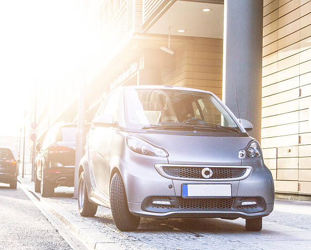 Berlin, Germany - December 9, 2014: The ultra-compact Smart car, a product of the Daimler AG, Stuttgart, parked in a public outdoor parking area.