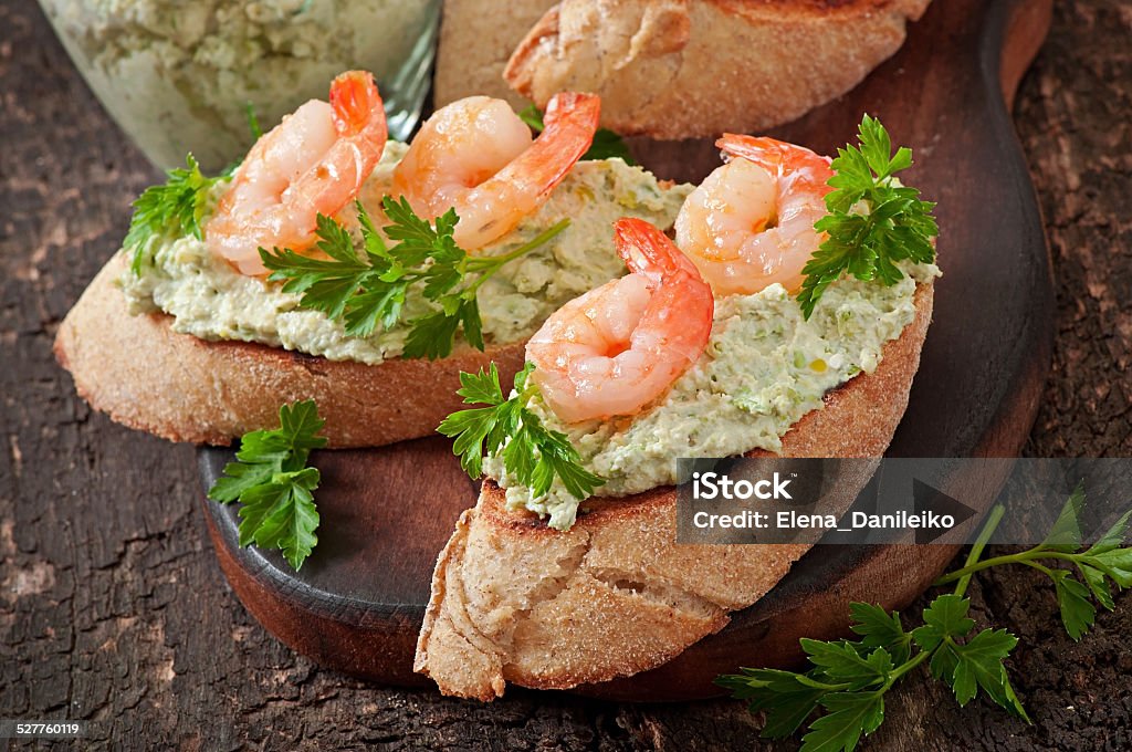 Bruschetta with a paste of green peas and shrimps Appetizer Stock Photo
