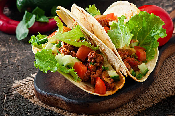 istock Mexican tacos with meat, vegetables and cheese 527762161