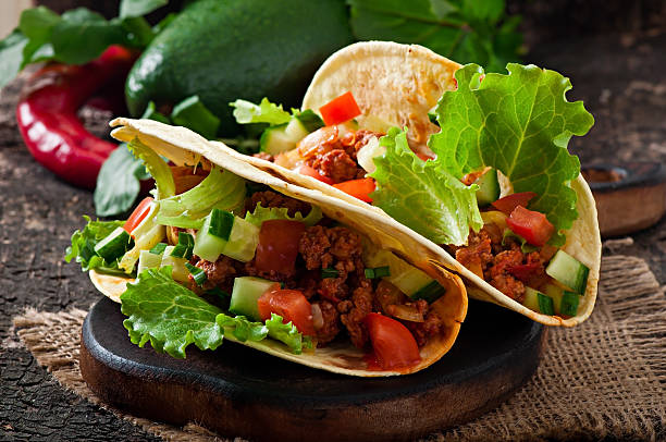 istock Mexican tacos with meat, vegetables and cheese 527763615