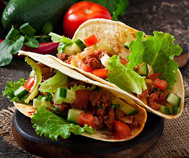 istock Mexican tacos with meat, vegetables and cheese 527763617