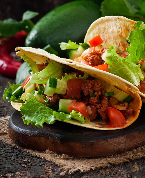 istock Mexican tacos with meat, vegetables and cheese 527763619