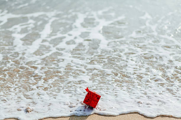 istock gift red box in the sea 527764003