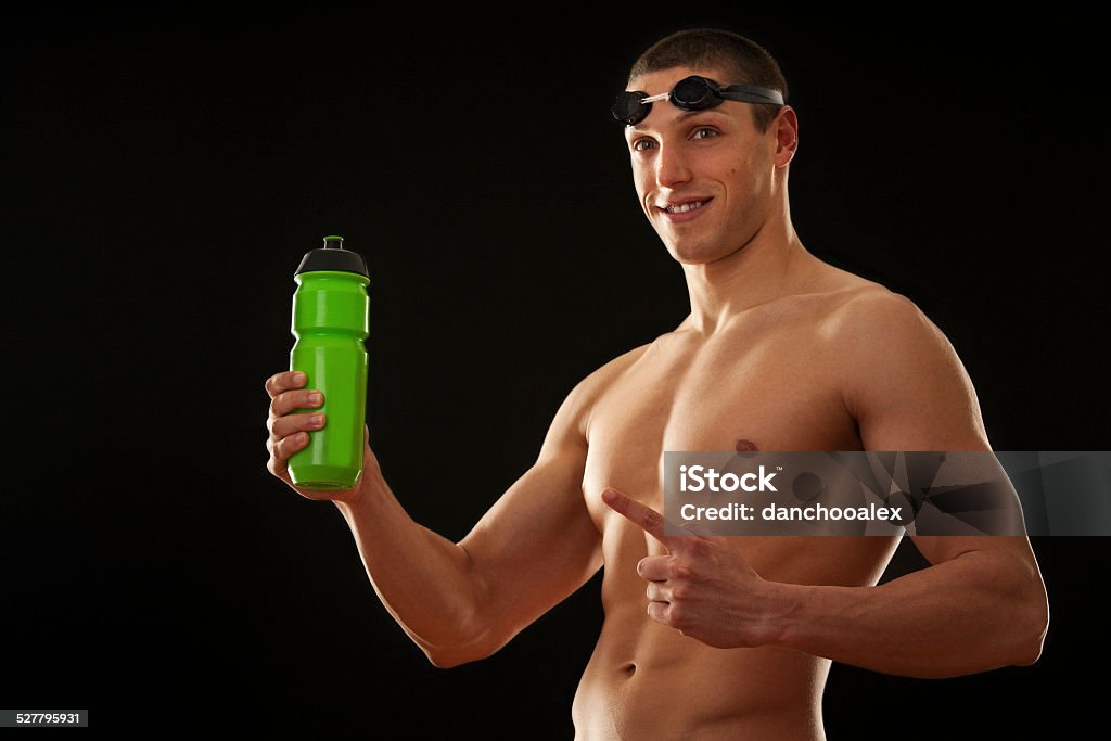 Muscular male swimer holding bottle Active Lifestyle Stock Photo