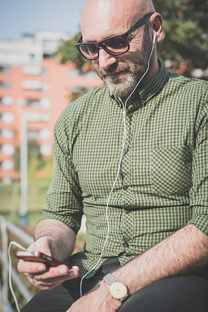 istock handsome middle aged man listening to music 527795971