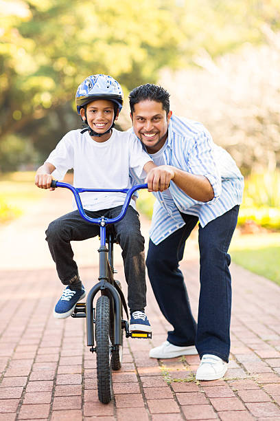 istock little indian boy learning to ride a bike 527796857