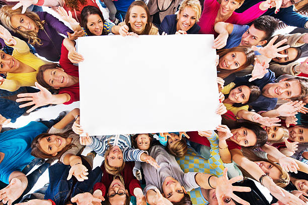 istock Group of happy people holding white paper. 527797175