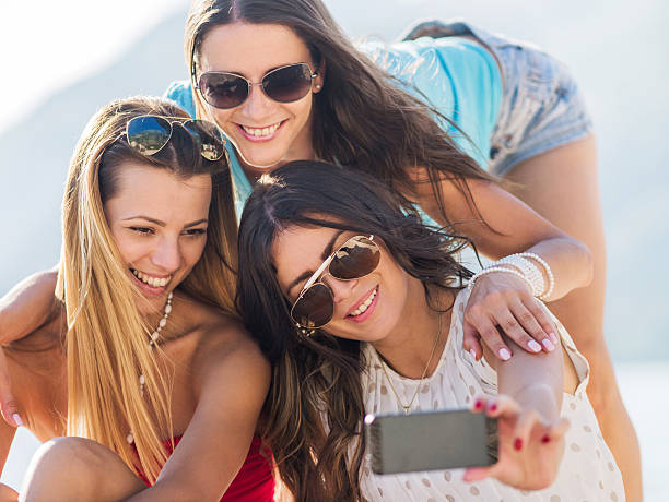 istock Friends taking a selfie with smart phone. 527797543