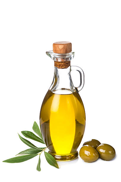 istock Extra olive oil bottle and green olives on white background 527799081