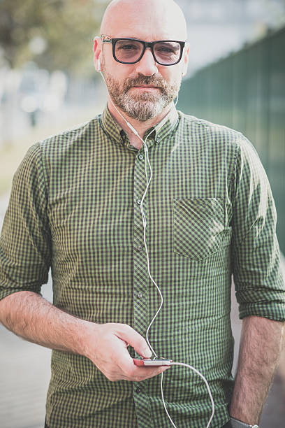istock handsome middle aged man listening to music 527814561