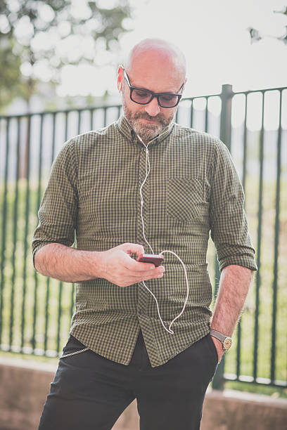 istock handsome middle aged man listening to music 527814589