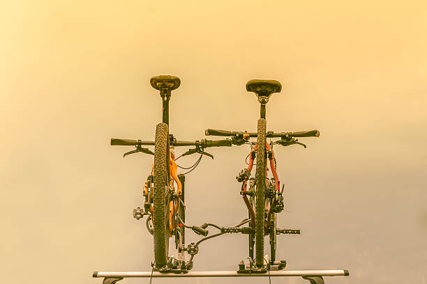 Two bicycles mounted on the car roof stock photo