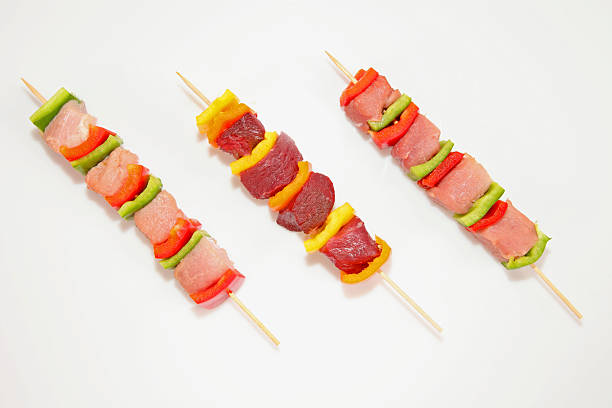 istock Raw shish kebab skewers on white background 527819507