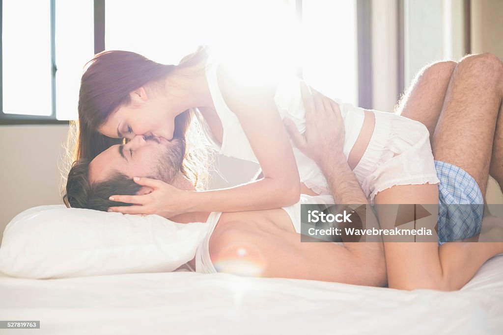 Young couple having fun in bed Young couple having fun in bed at home in bedroom 20-24 Years Stock Photo