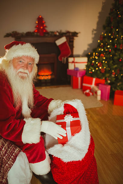 istock Smiling father christmas stocking presents 527820129