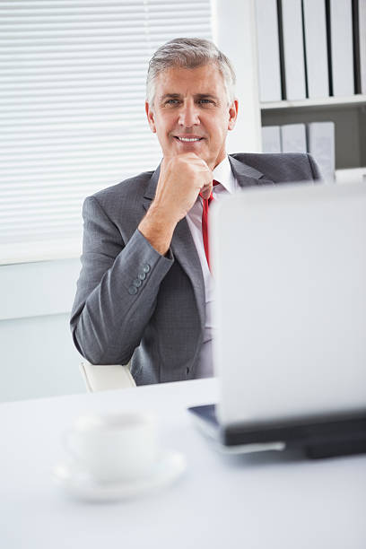 istock Happy businessman at his desk 527821071