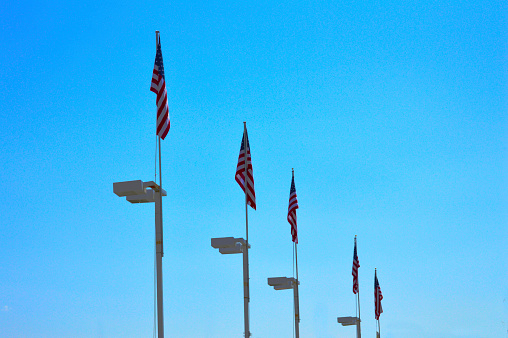 USA flags on file blue sky background photo