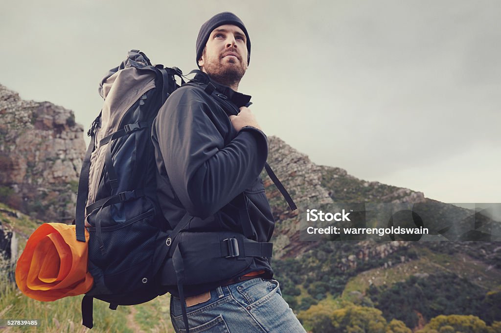 mountain trekking man Adventure man hiking wilderness mountain with backpack, outdoor lifestyle survival vacation Directly Below Stock Photo